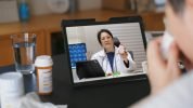 Telehealth concept,asian woman video call with her doctor about  fever illness while staying at home. Close up of patient about illness in video conferencing with general practitioner on digital tablet.